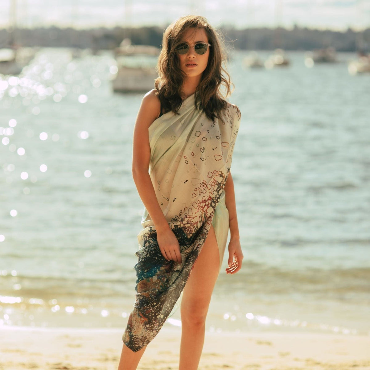 Figments of Imagination silk cotton sarong so stylishly worn as a Grecian wrap at the beach reflecting the serene blues and soft creamy coloured sands.