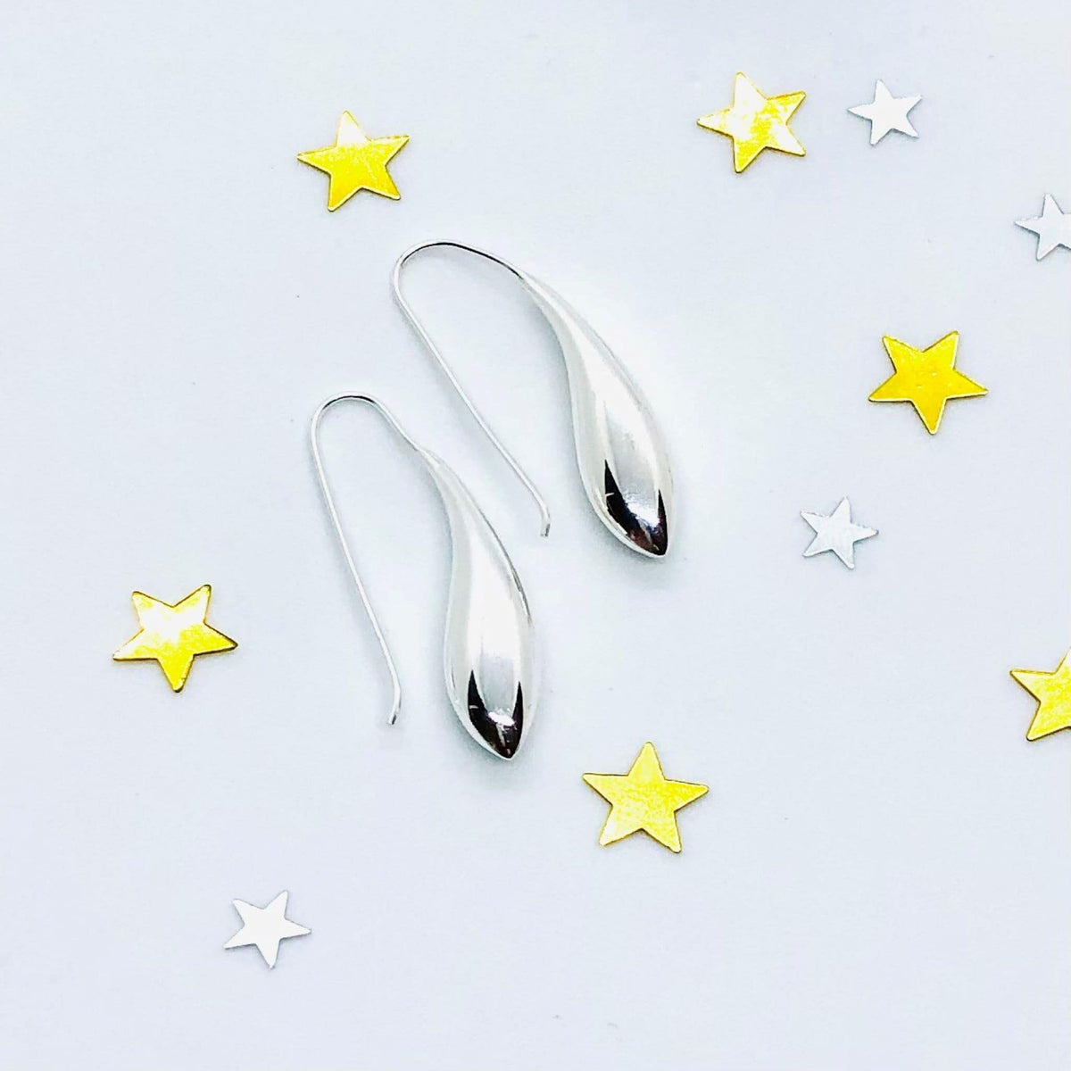 Sterling silver teardrop shape earrings with shepherd hook fixture. Smooth fluid lines and high polish finish. Perfect Christmas gift.