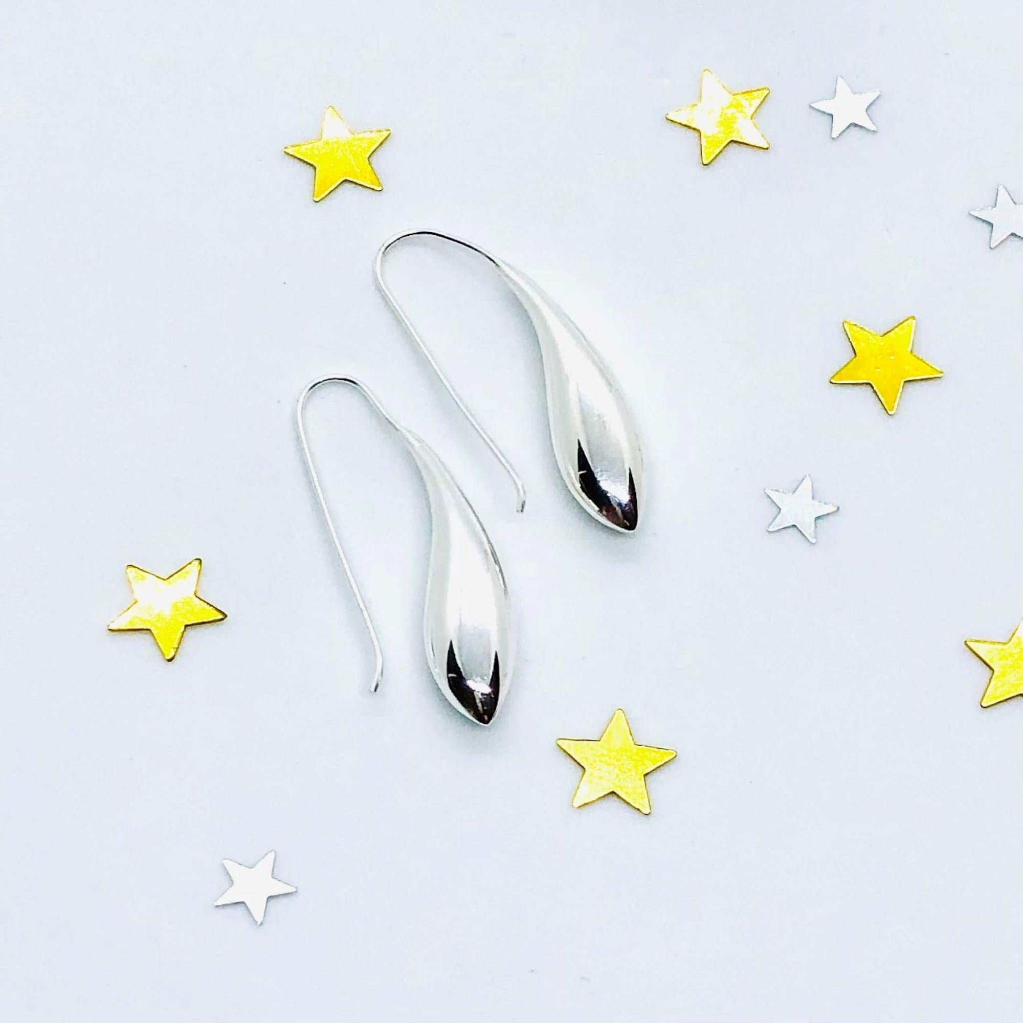 Sterling silver teardop earrings with shepherd hook fixture. Smooth fluid lines accentuate the teardrop shape. High polish finish. Comes in its own taupe coloured box with black gloss base and finished with black grosgrain bow.